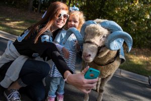 UNC Fans pose with Rameses 2 before a football game.